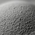 A close up view of a textured surface covered in fine dark granular particles Royalty Free Stock Photo
