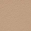 A close-up view of a textured surface resembling light beige stucco or rough plaster. Royalty Free Stock Photo