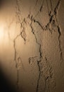 Close-up view of a textured wall surface with visible cracks and rough patches. The Royalty Free Stock Photo