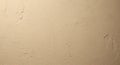 A close-up view of a textured wall with a uniform light brown color. The surface shows subtle Royalty Free Stock Photo