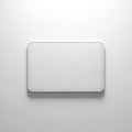 A close-up view of a textured white rectangular object against a plain background Royalty Free Stock Photo