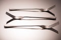 close-up view of three arranged shiny forks reflected Royalty Free Stock Photo