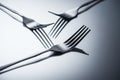 close-up view of three shiny forks reflected on grey Royalty Free Stock Photo