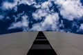 Close-Up View of Tiled Wall Outdoors Leading Deep Blue Sky and Clouds Royalty Free Stock Photo