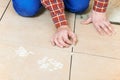 Tiler hands at home renovation work Royalty Free Stock Photo