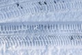 Close up view tire tracks at the surface of fresh fallen snow Royalty Free Stock Photo