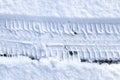 Close up view tire tracks at the surface of fresh fallen snow Royalty Free Stock Photo