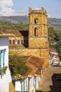 Close-up view to the bell towers of Cathedral of the immaculate conception from a higher angle, typical houses in front, Barichara