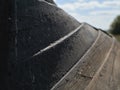 Close up view to the bottom of wooden flipped boat on the ground against blue sky. Royalty Free Stock Photo