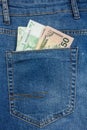 Close Up View to 100 euro and 50 dollar Banknotes Sticking Out From a Blue Jeans Pocket Royalty Free Stock Photo