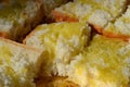 Close-up view to fresh cubic pieces of a high quality bread with olive oil poured on them. Royalty Free Stock Photo