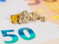 Close up view to the golden nugget grain on fifty euro banknote, selective focus. Copy space. Royalty Free Stock Photo