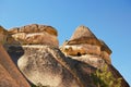 Close-up view top of the famous Fairy Chimneys or Multihead stone mushrooms in Pasaba Valley near Goreme. Blue sky background. Royalty Free Stock Photo