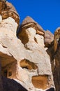 Close-up view top of the famous Fairy Chimneys or Multihead stone mushrooms in Pasaba Valley near Goreme. Blue sky background. Royalty Free Stock Photo