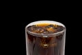 Close up view of top of full glass of soda with ice cubes isolated on black background. Unhealthy drinks concept. Royalty Free Stock Photo