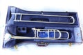 Close-up view, top view, musical instrument Trombone in black box, isolated object, white background.