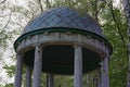 Close-up view of the top of old wooden pavilion in the birch grove. Green trees in the background Royalty Free Stock Photo