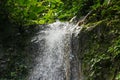 Close up view of the top of the waterfall in the forest Royalty Free Stock Photo