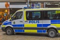 Close up view of tourist pedestrian area with shops and police car in downtown.