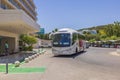 Close up view of tourists buss near hotel building.