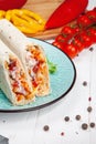 Close up view on traditional Arab shawarma, shaurma or kebab on blue plate stands on white background. Freh doner with ingridients Royalty Free Stock Photo