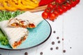 Close up view on traditional Arab shawarma, shaurma or kebab on blue plate stands on white background. Freh doner with ingridients Royalty Free Stock Photo