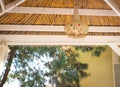 Close up view of a traditional bamboo lampshade hanging on the roof of the garden gazebo