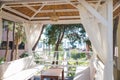 Close up view of a traditional bamboo lampshade hanging on the roof of the garden gazebo