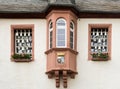 Traditional German architecture in Rudesheim with decorative windows and a coat of arms