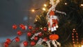 Close-up view of traditional Christmas holiday nutcrackers figurine hanging on a Christmas Tree near the lights and Royalty Free Stock Photo