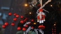 Close-up view of traditional Christmas holiday nutcrackers figurine hanging on a Christmas Tree near the lights and Royalty Free Stock Photo