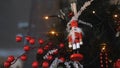 Close-up view of traditional Christmas holiday nutcrackers figurine hanging on a Christmas Tree near the lights and Royalty Free Stock Photo