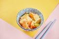 Close up view on traditional kimchi cabbage in blue bowl on colorful background. pan-asian cuisine Royalty Free Stock Photo