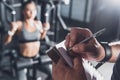 close up view of trainer writing in notebook while woman Royalty Free Stock Photo