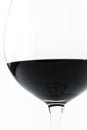 Close up view of a transparent glass full of red wine on a white background Royalty Free Stock Photo