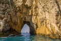 A close up view through the tunnel of love sea arch in the Faraglioni rocks on the eastern side of the Island of Capri, Italy Royalty Free Stock Photo