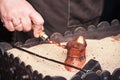 Close up view of turkish coffee prepared on hot golden sand. Coffee preparation concept Royalty Free Stock Photo