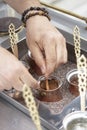 Close up view of turkish coffee prepared on hot golden sand Royalty Free Stock Photo