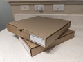 Close up view of two cardboard pizza boxes on a kitchen counter top Royalty Free Stock Photo