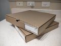 Close up view of two cardboard pizza boxes on a kitchen counter top Royalty Free Stock Photo