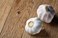 Close up view of two garlic bulbs arranged on a rustic wooden background, shallow depth of field, selective focus, macro