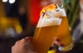 Close-up view of a two glass of beer in hand. Beer glasses clinking in bar Royalty Free Stock Photo