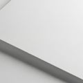 Close-up view of two overlapping sheets of white paper. The top sheet has a smooth texture, Royalty Free Stock Photo
