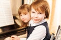 Close-up view of two small girls playing piano Royalty Free Stock Photo