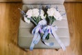Close-up view of twoo bouquets of white roses and lavender wrapped with ribbons.