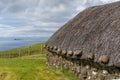Close-up view of a typical crofter cottage with thick stone walls and a thatched reed roof Royalty Free Stock Photo