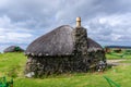 Close-up view of a typical crofter cottage with thick stone walls and a thatched reed roof Royalty Free Stock Photo