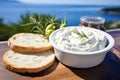 Close up view of tzatziki on Greek table, sea in background