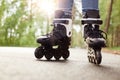 Close up view of unknown person rollerblading in park on sunny day, being on road, spending time in fresh air, enjoying hobby Royalty Free Stock Photo