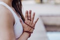 close up view of unrecognizable young asian woman doing yoga in a park. Sitting on the bridge with praying hands position and Royalty Free Stock Photo